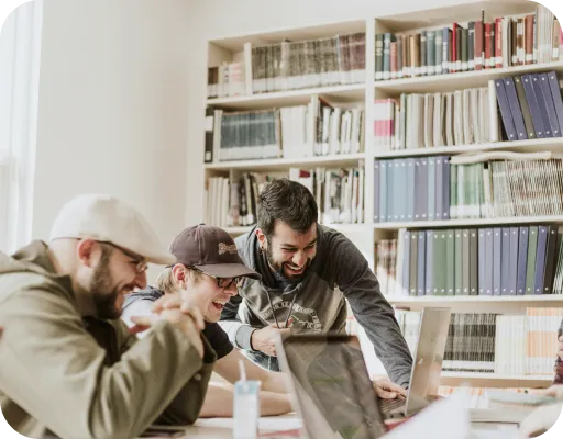 Young people in library looking at computer screen