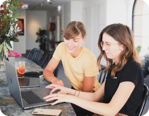 Two people looking at a computer together