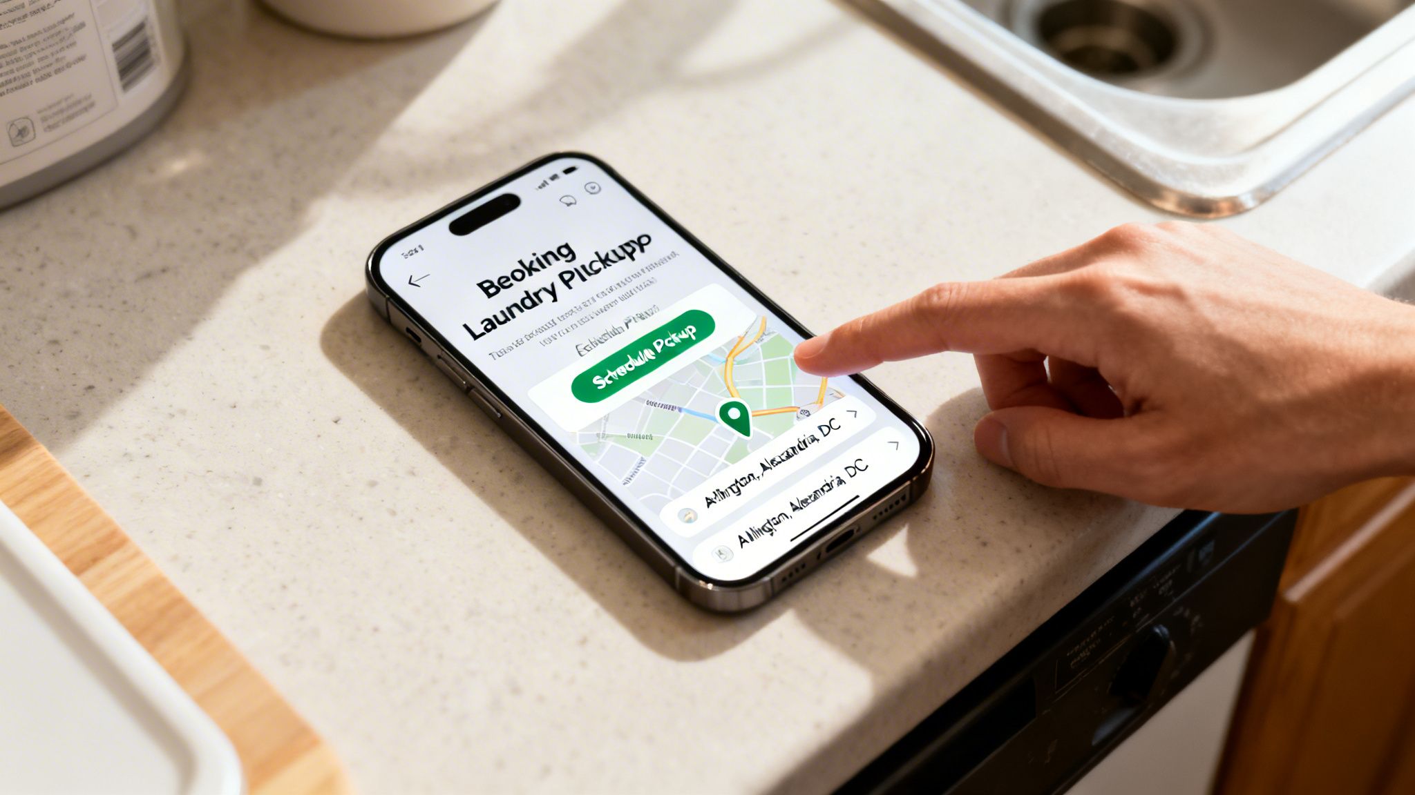 A person uses a smartphone to book laundry pickup, displaying a map and location on the app.