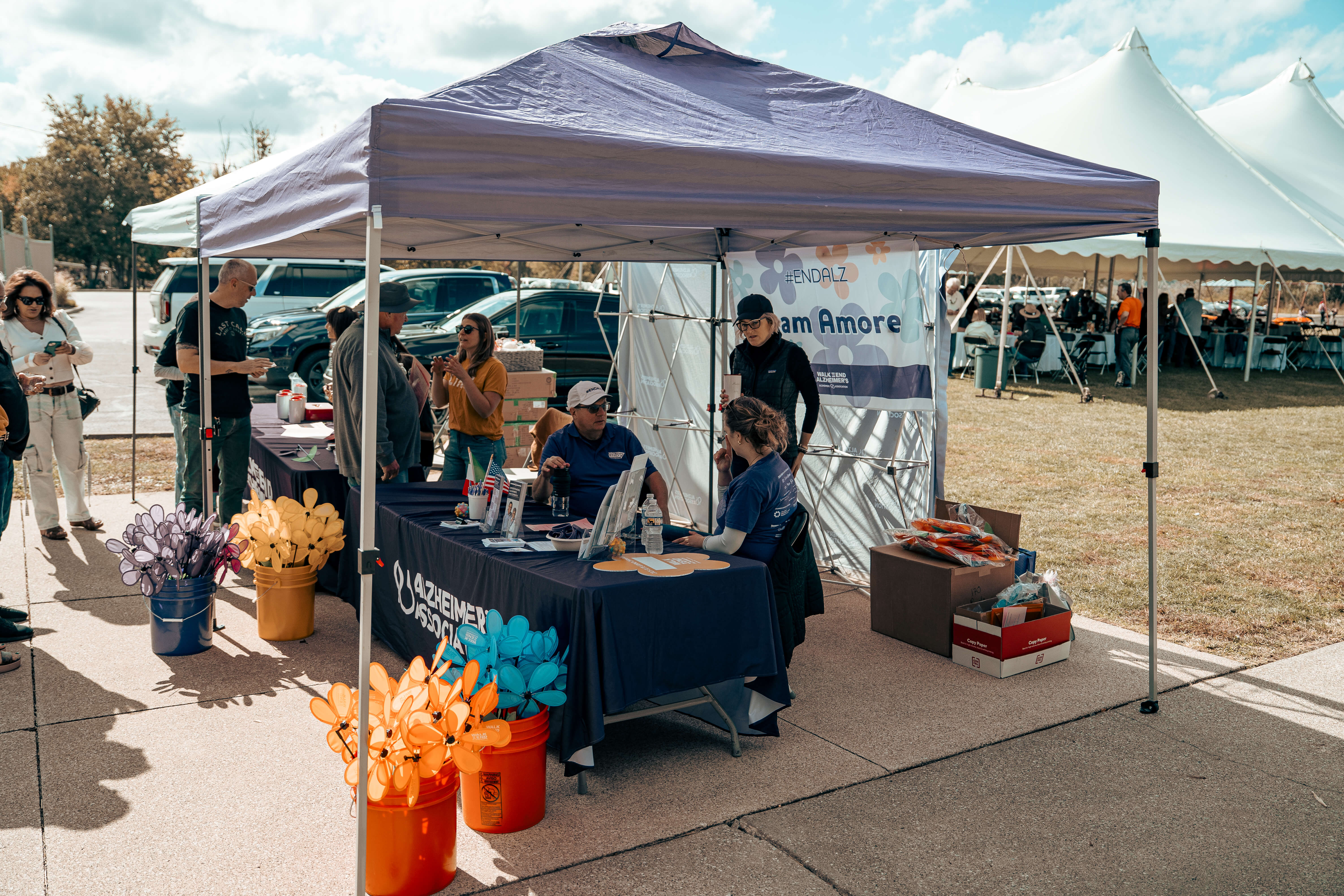 Alzheimer's Association fundraising booth with volunteers and colorful decorations