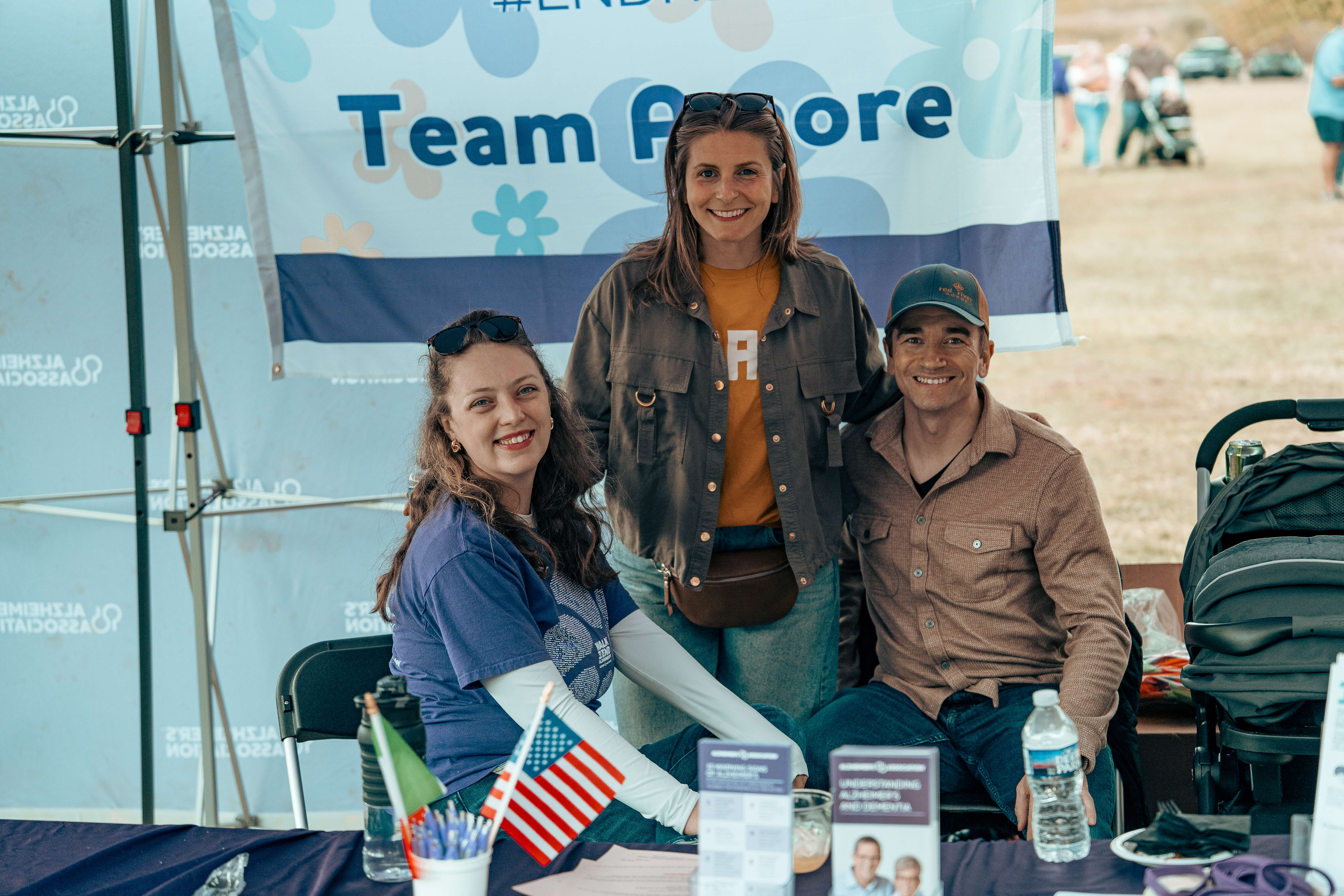Team Amore volunteers at community event with American flag