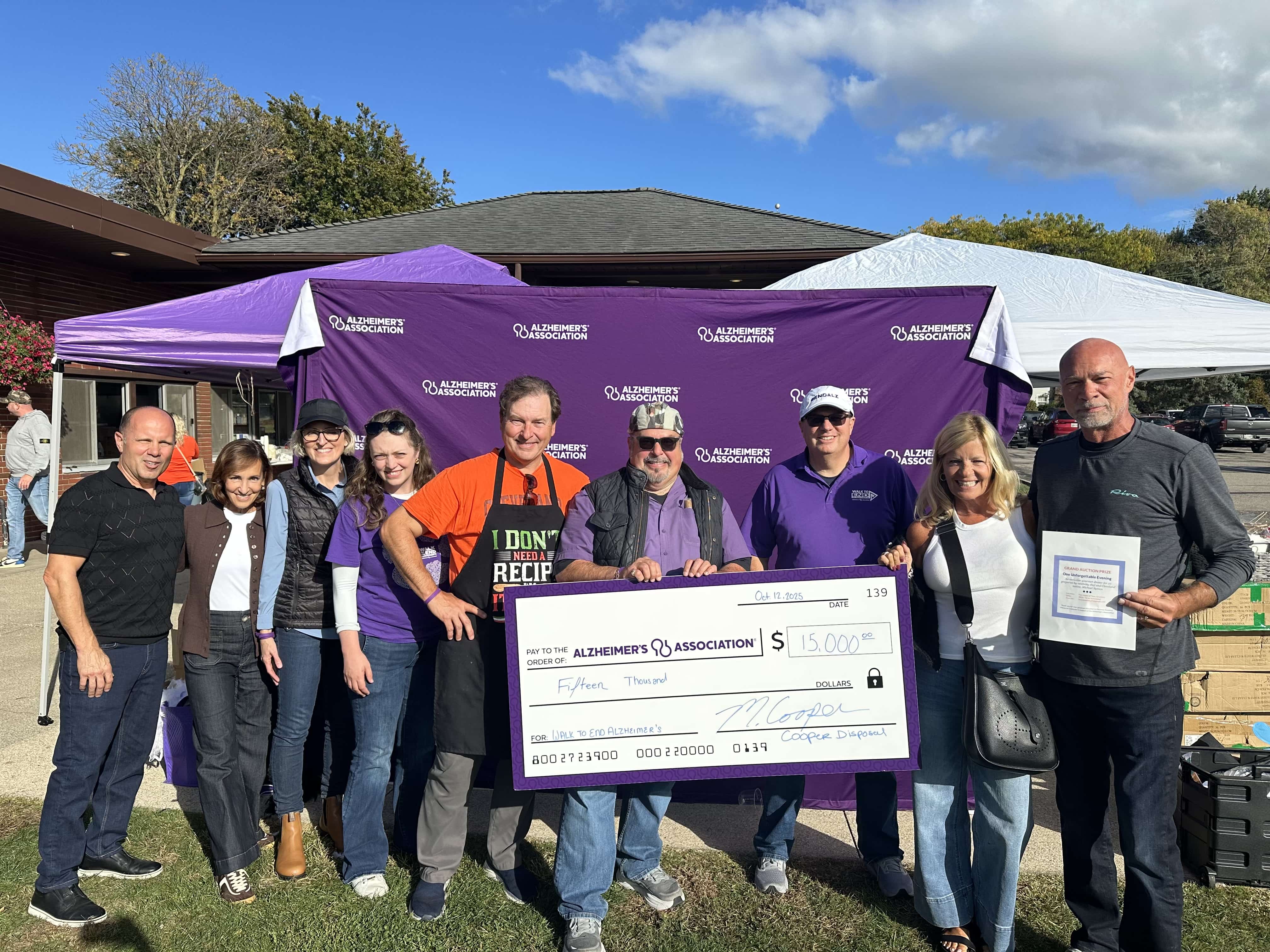 Alzheimer's Association fundraising event with large donation check presentation