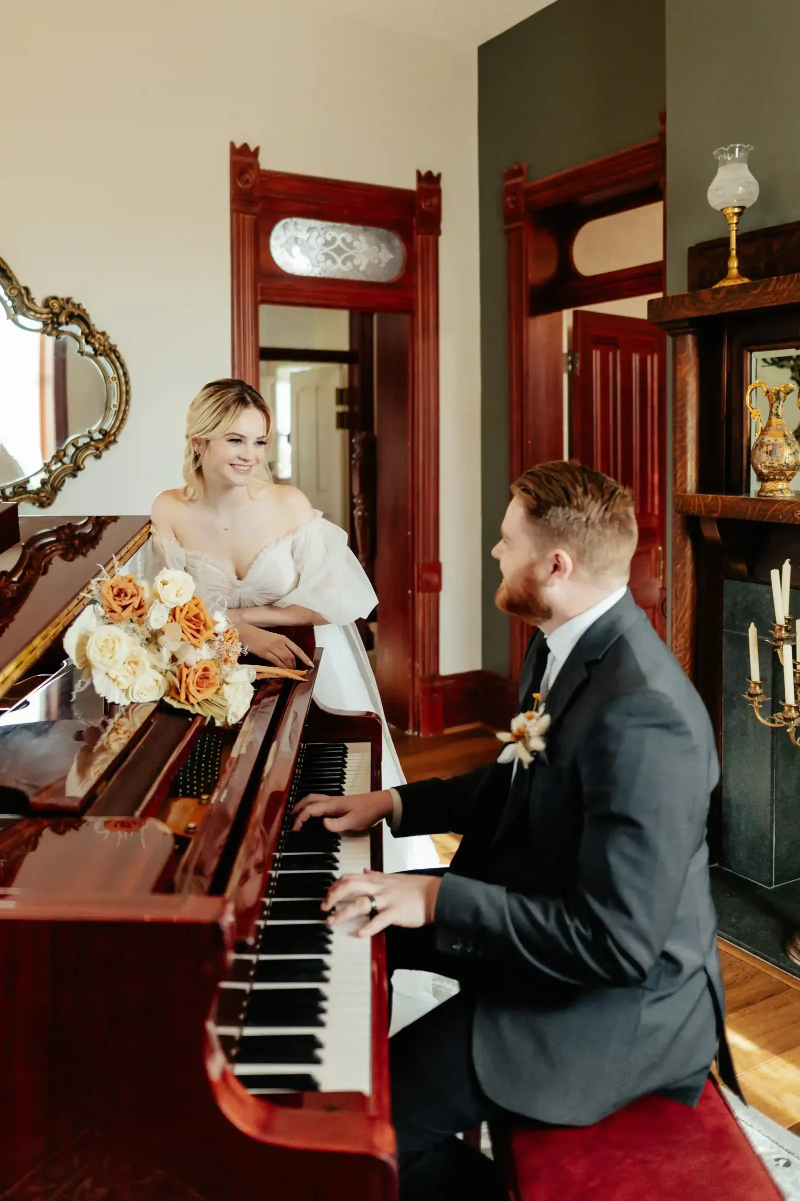 A couple at the grand piano inside the house