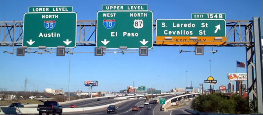 Highway signs in San Antonio for Interstate 35 (I-35) North to Austin and Interstate 10 (I-10) West to El Paso, indicating the Lower Level, Upper Level, and Exit 154B.
