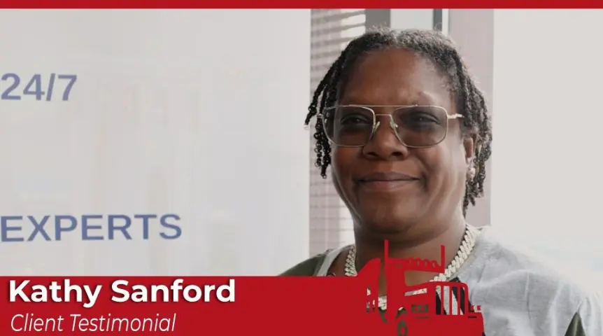 A portrait of Kathy Sanford, a Black woman with short dreadlocks, glasses, and a silver chain necklace, smiling slightly. A red banner graphic identifies her as "Kathy Sanford" and features a "Client Testimonial." 