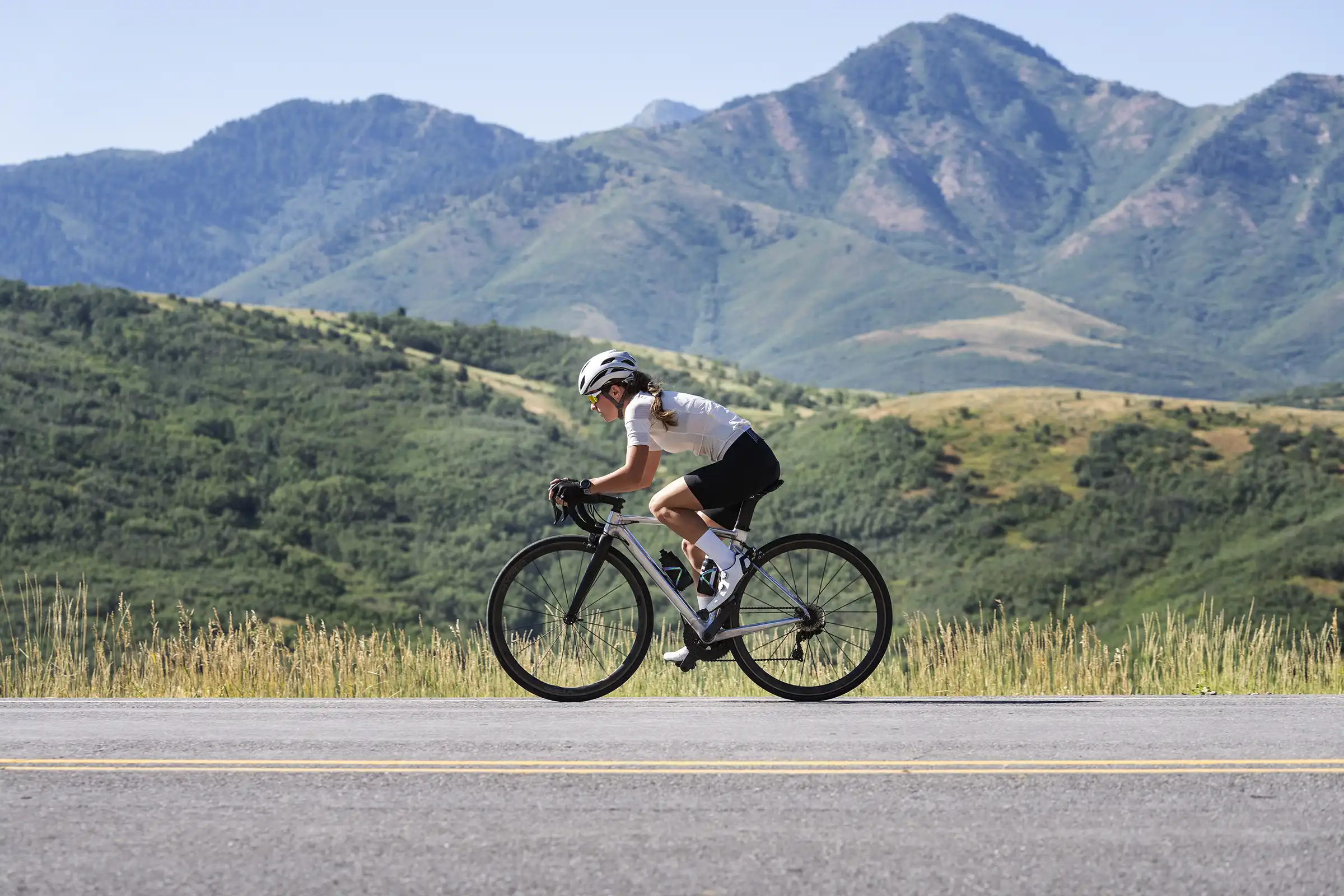 Cyclist woman side profile with mountains in background