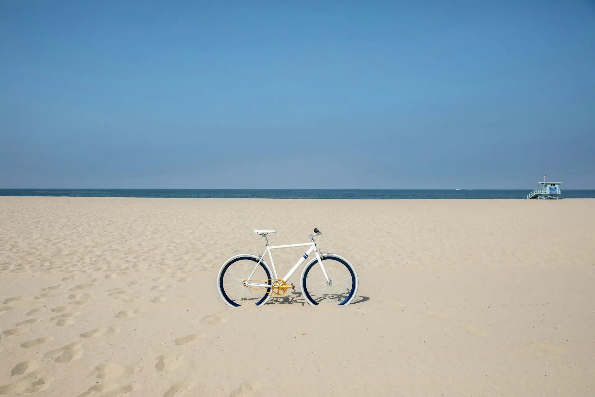 White bicycle on the sand on the beach