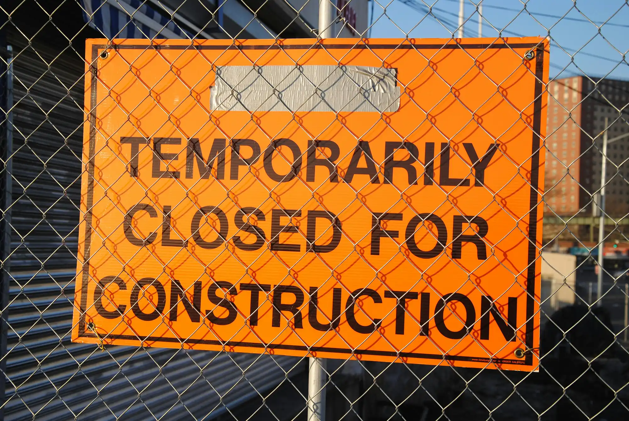 Orange construction sign saying closed