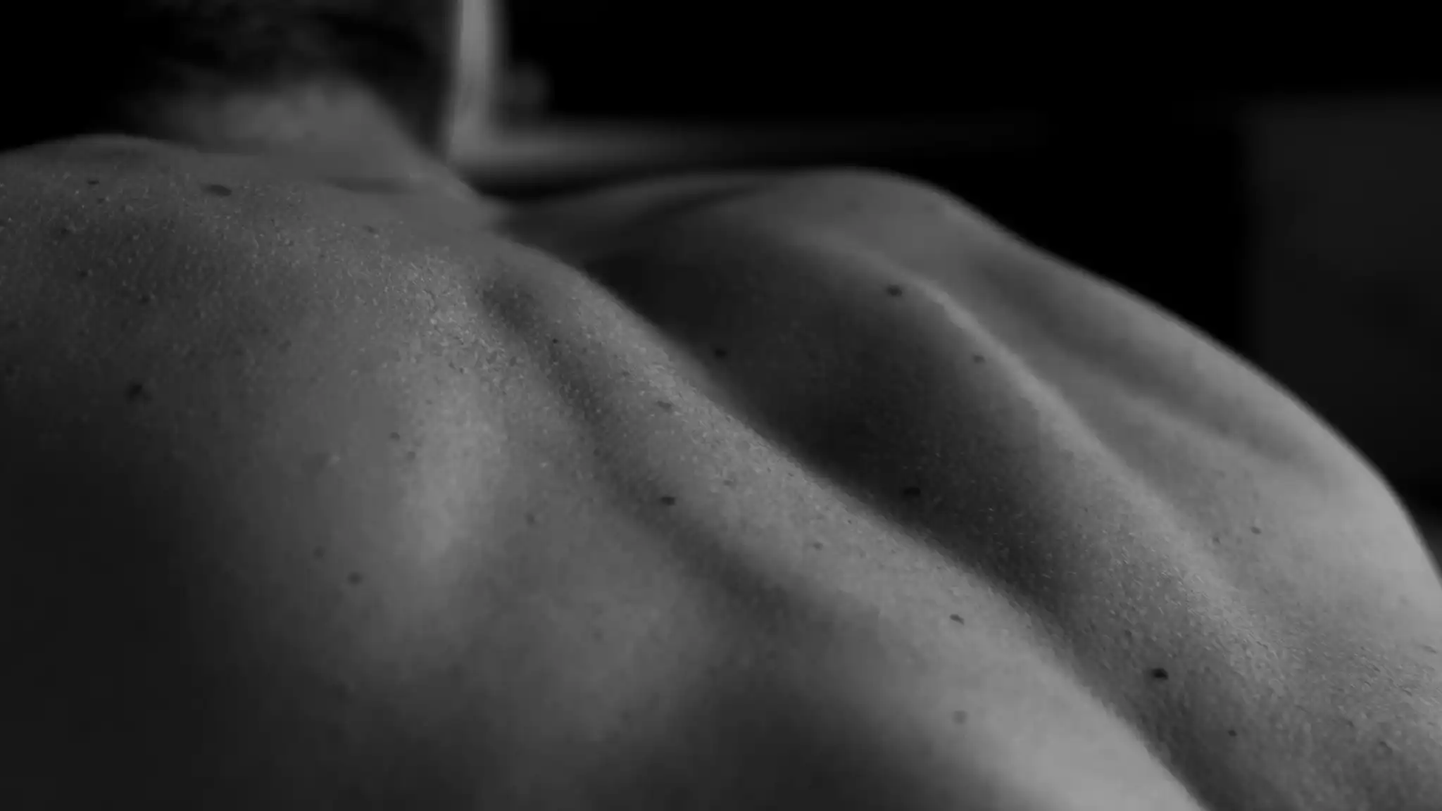 Black and white photograph of a man's back and spine