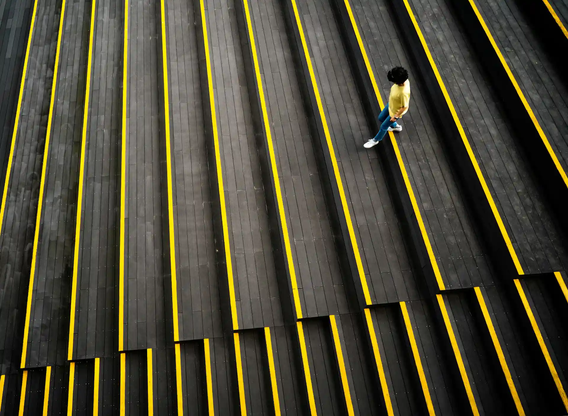 Yellow warning strips on stair edges highlighting premises liability fall hazards in San Diego
