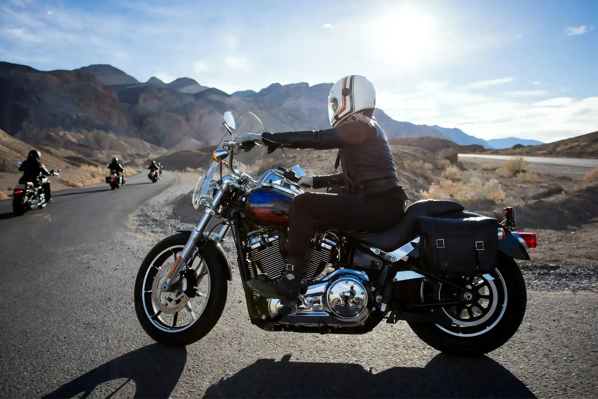 Motorcycle rider on a mountain road representing the serious injuries and financial losses that follow a crash