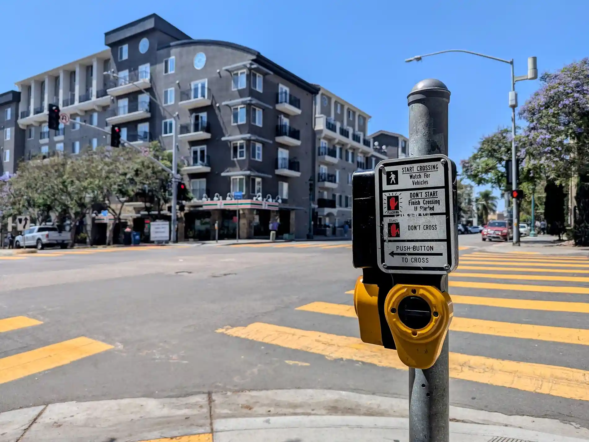 San Diego crosswalk intersection with pedestrian crossing button and marked crosswalk lines