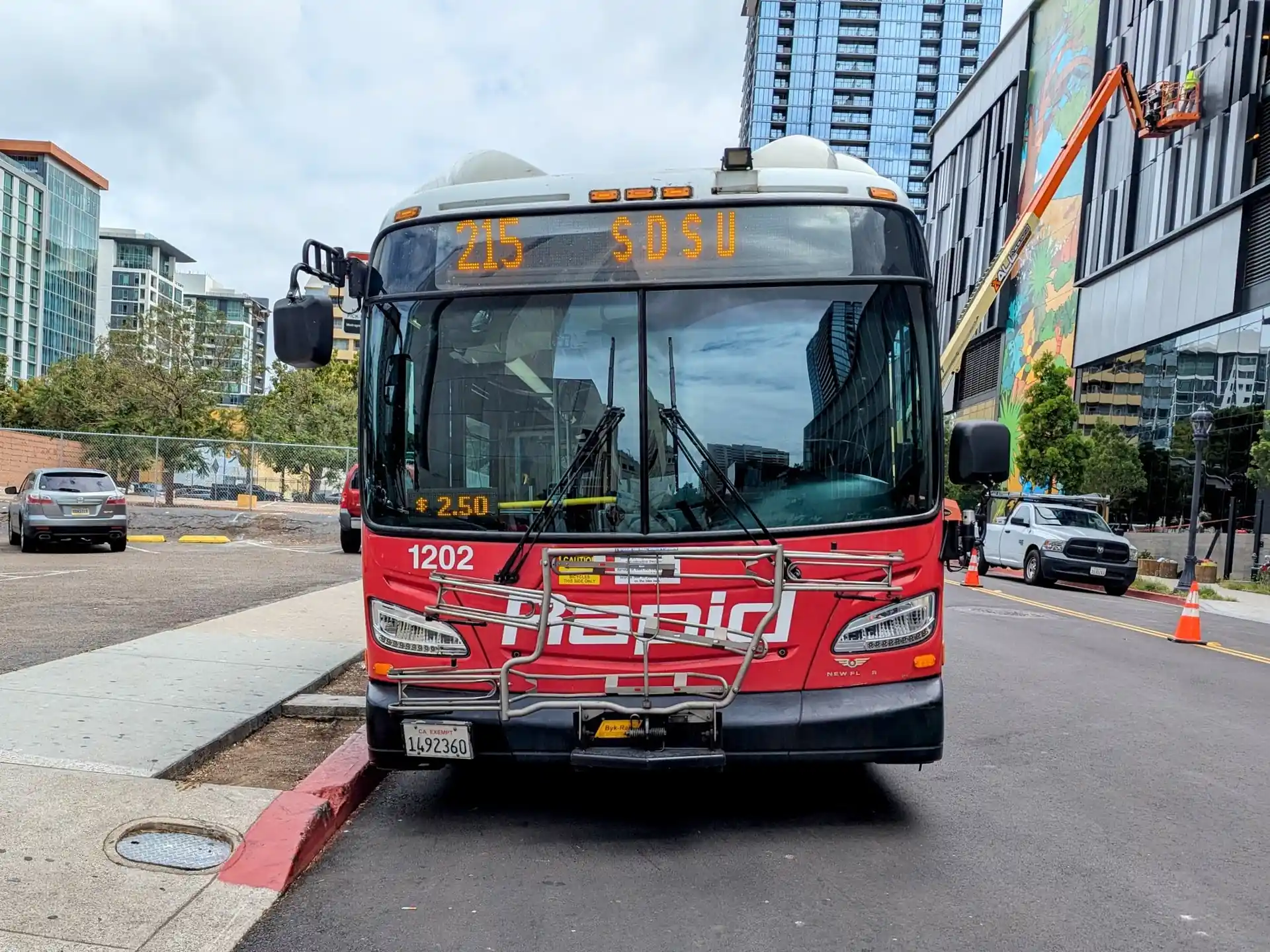 MTS Bus parked along San Diego sidewalk.