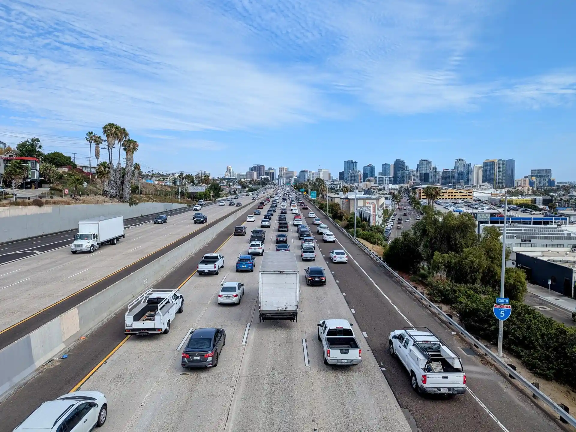 Interstate 5 freeway with traffic and downtown San Diego skyline.