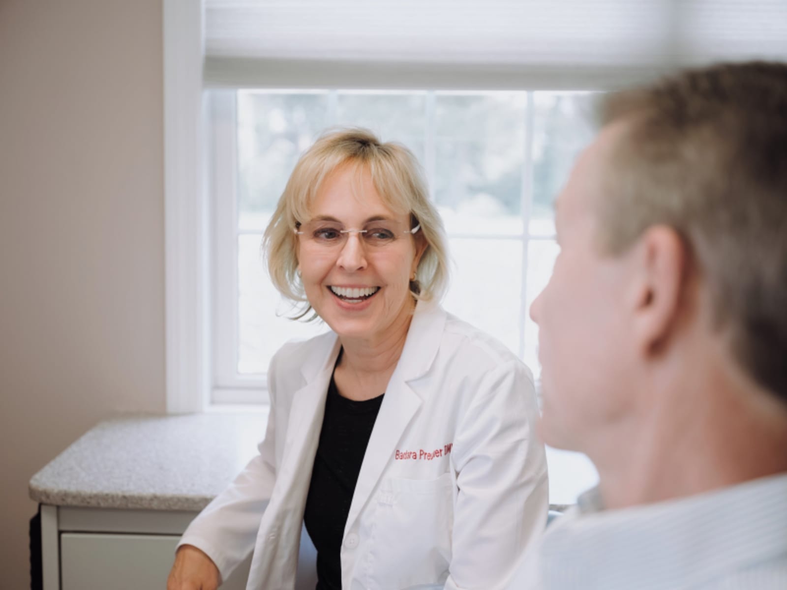 Dr. Barbara Preussner consulting with a patient in dental office during treatment planning