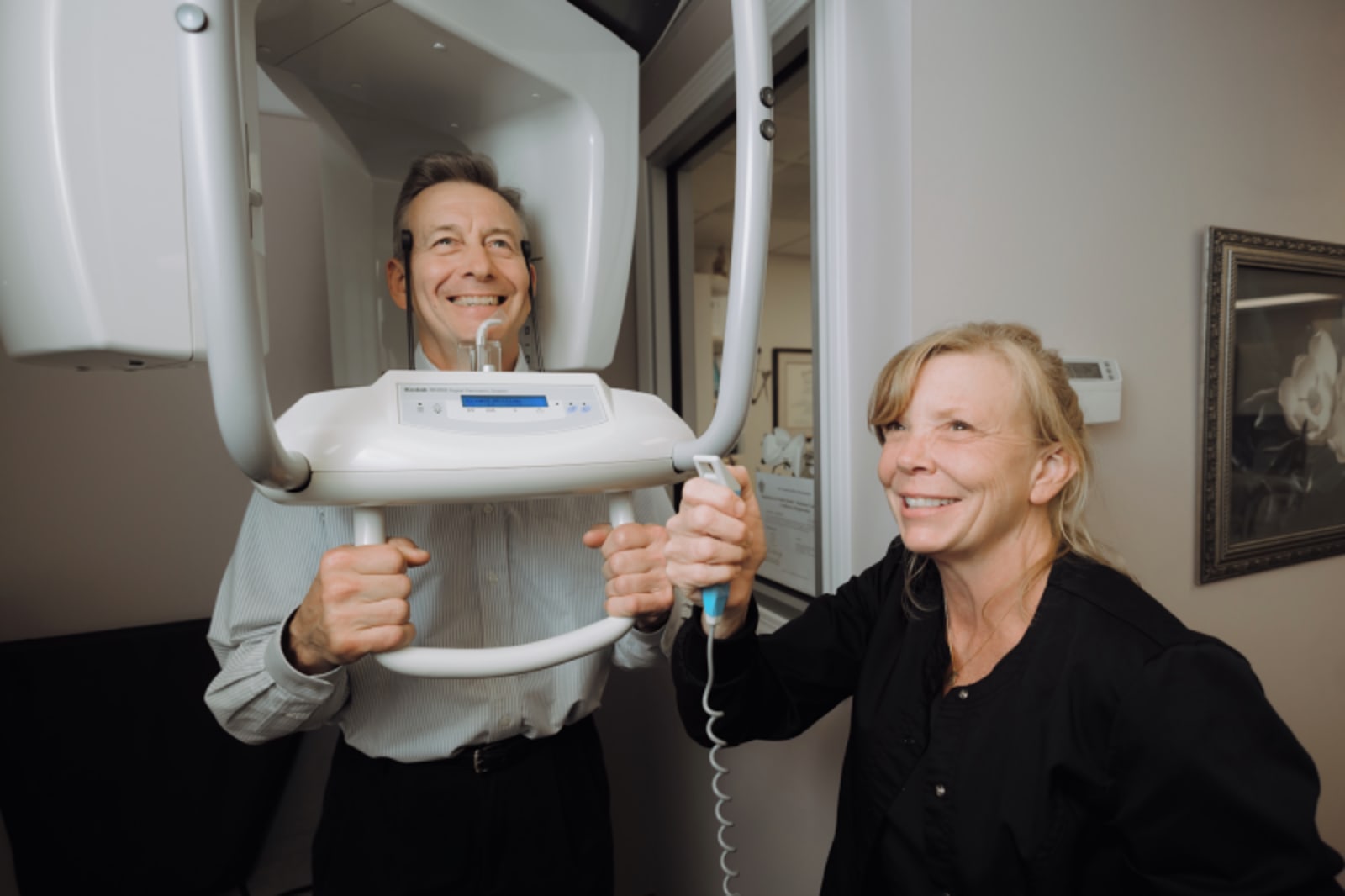 Dr. Preussner performing a visual assessment of a patient's teeth during examination