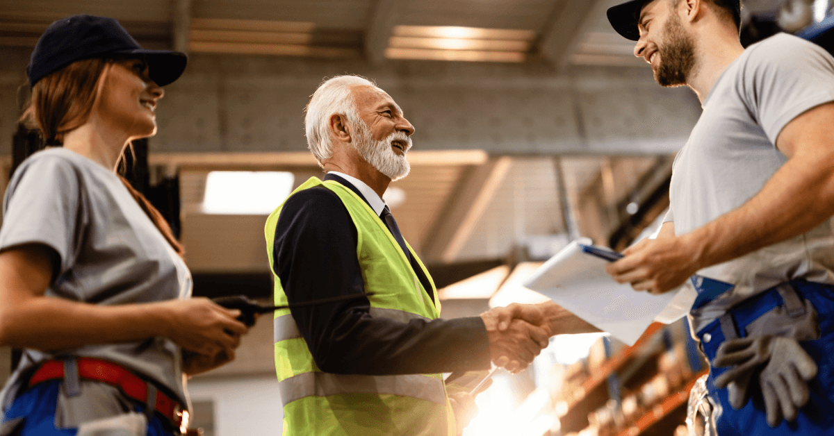 Warehouse workers and manager working together.