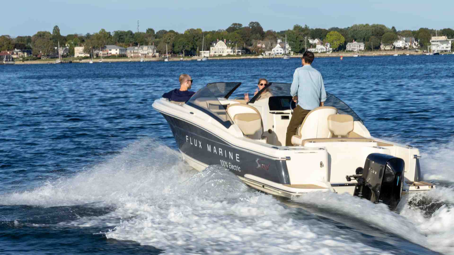 a person enjoying a quiet conversation on a boat powered by an electric outboard - electric marine outboard