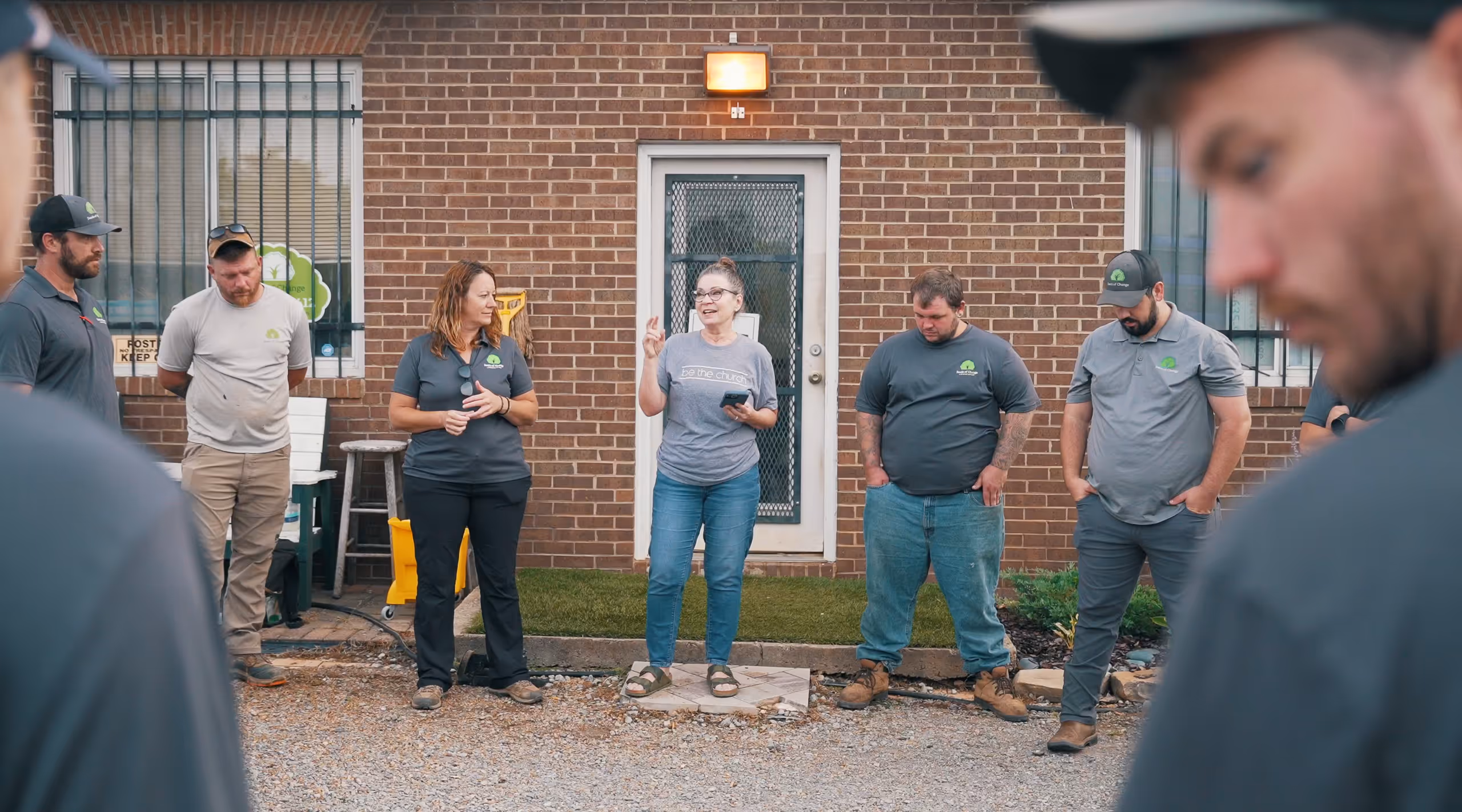 A group of working gathered around for a team meeting