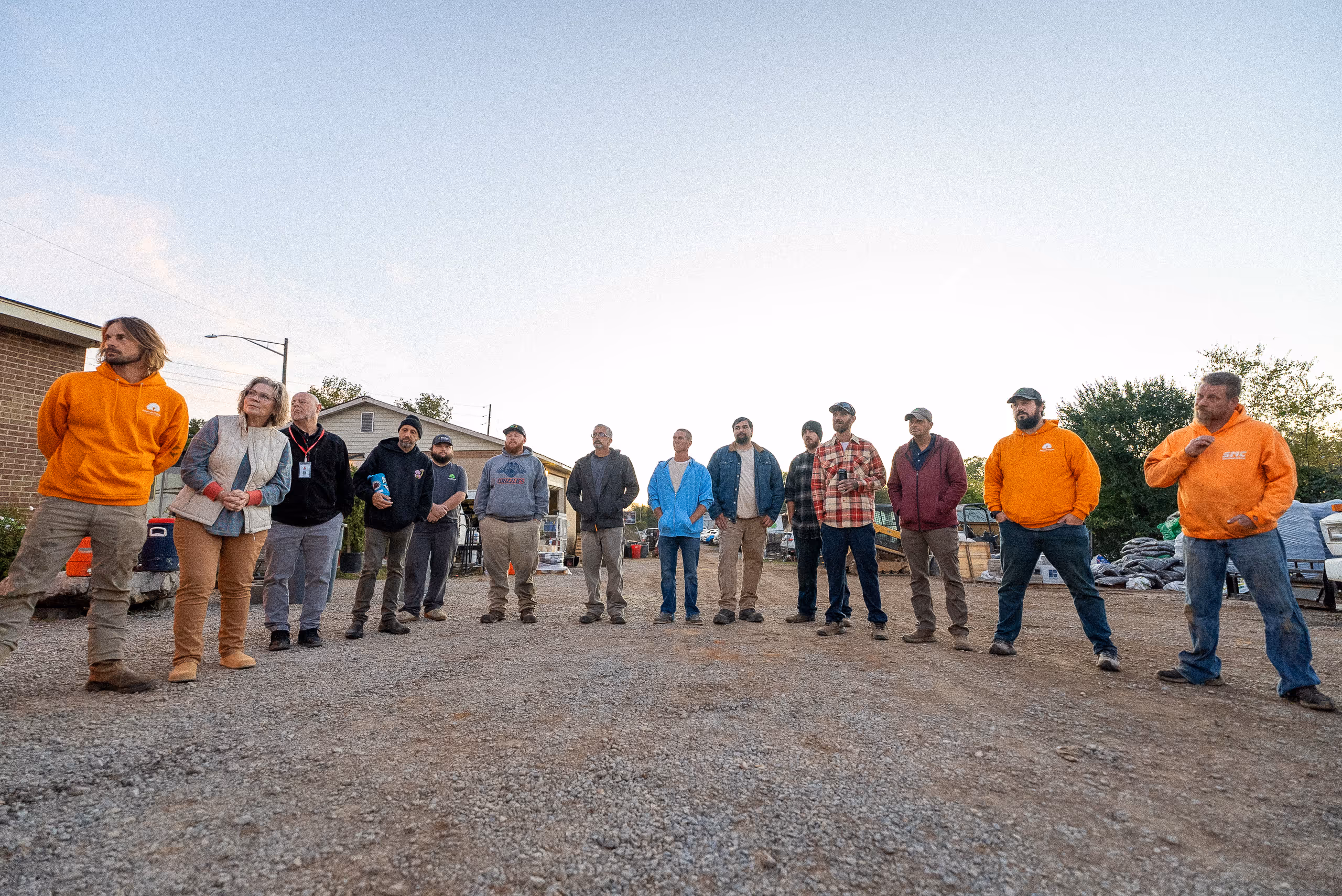 Group of people standing together outdoors during team gathering