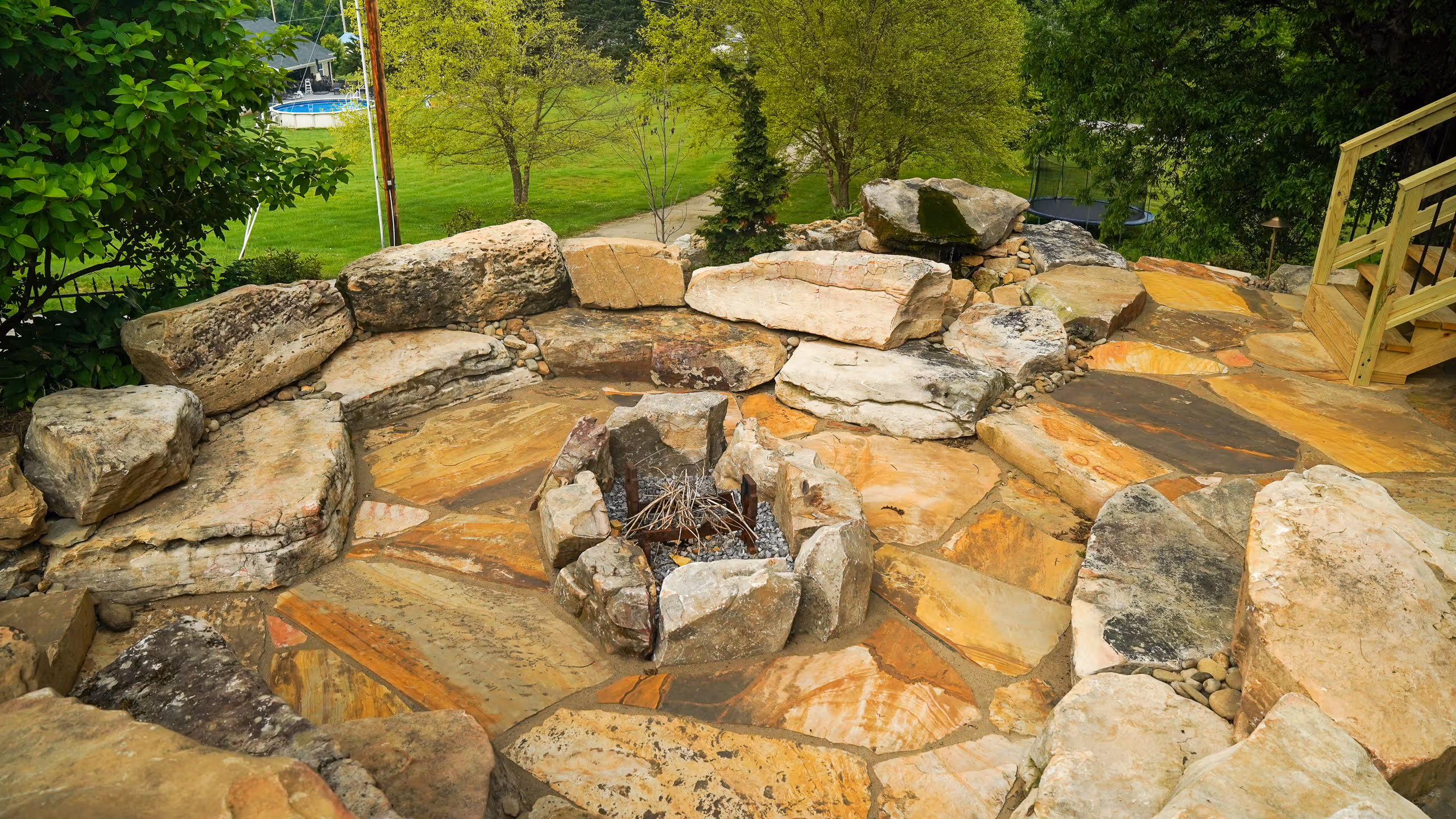 A stone fire pit surrounded by large rocks