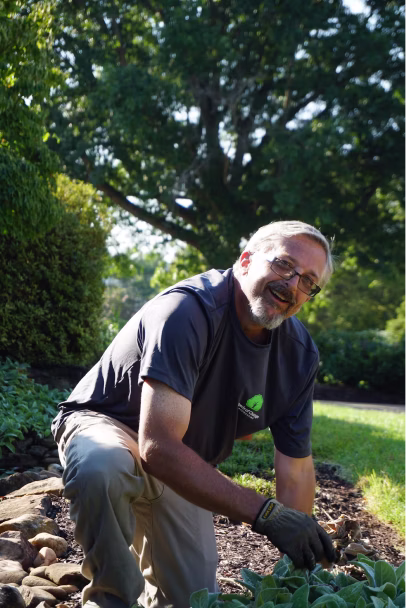A man smiling while gardening