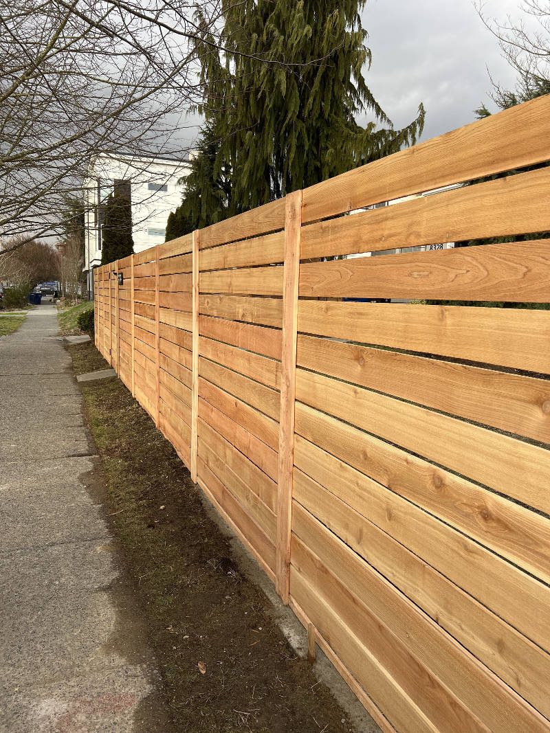 Close-up of treated wood fence boards during construction