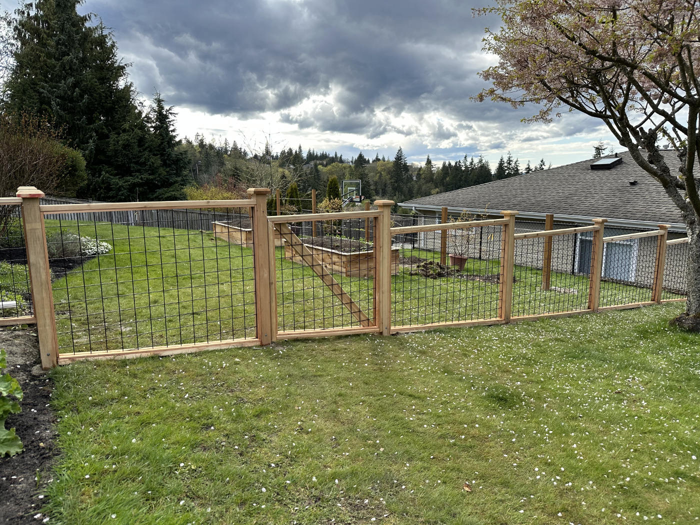 Wooden privacy fence being installed around a residential property