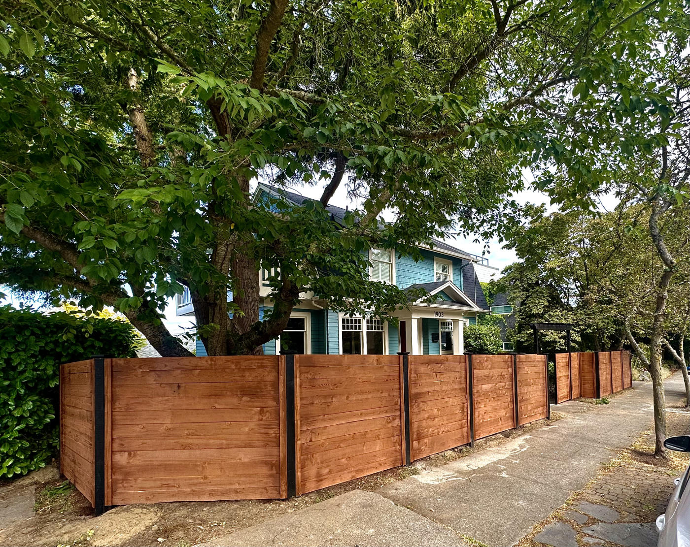 Horizontal slat wooden fence design for modern curb appeal