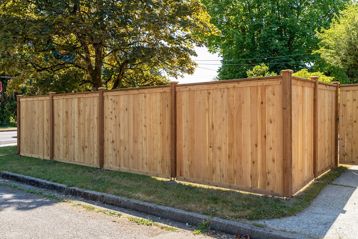 Wooden privacy fence along a residential sidewalk