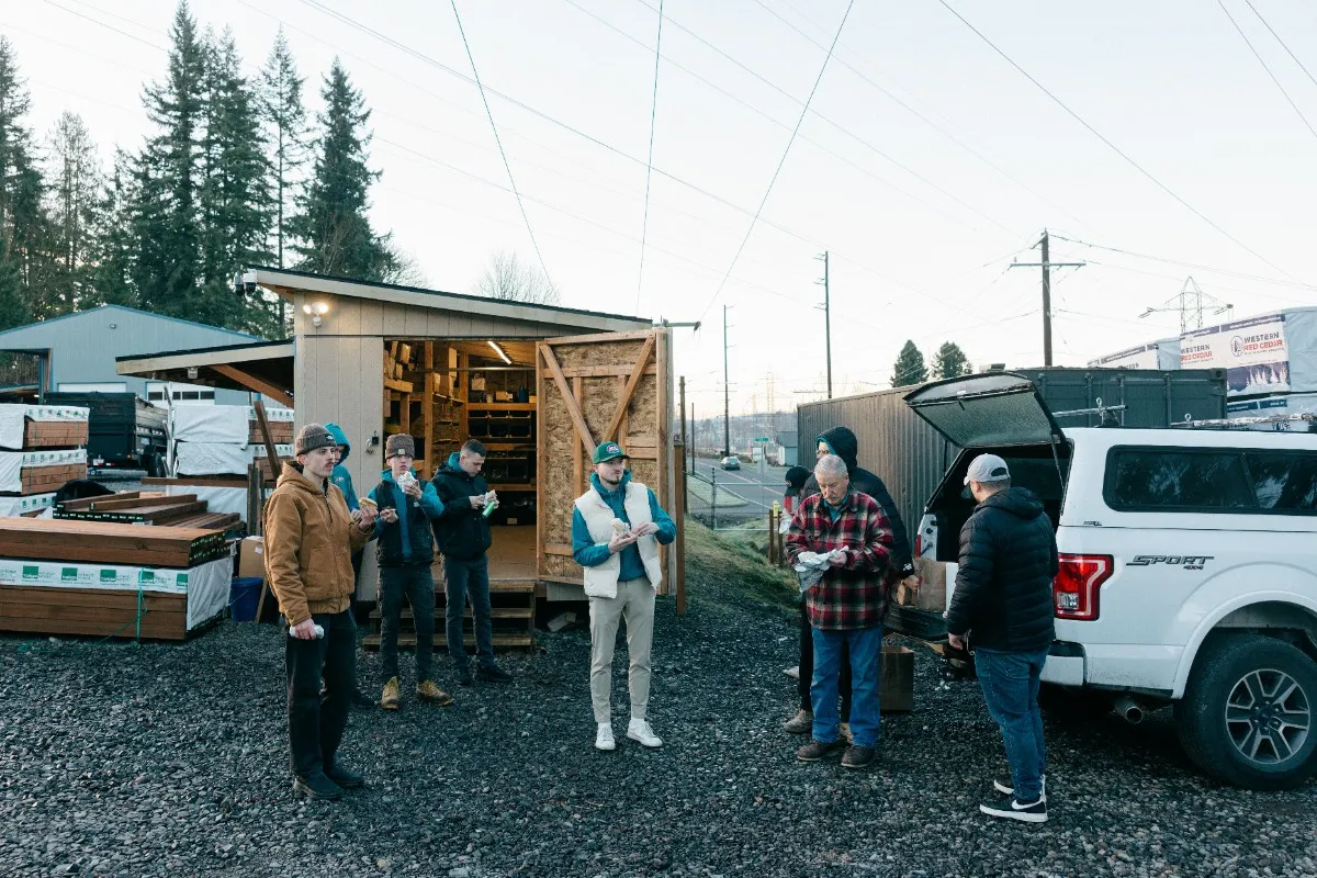 Fence builders sharing lunch near a toolshed in Seattle