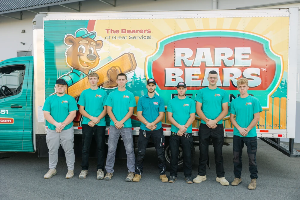 Rare Bears Fencing installation crew lined up in front of the branded box truck with the company bear mascot