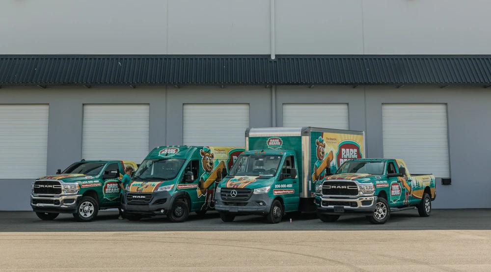 Rare Bears Fencing fleet of branded trucks and vans parked outside the company warehouse