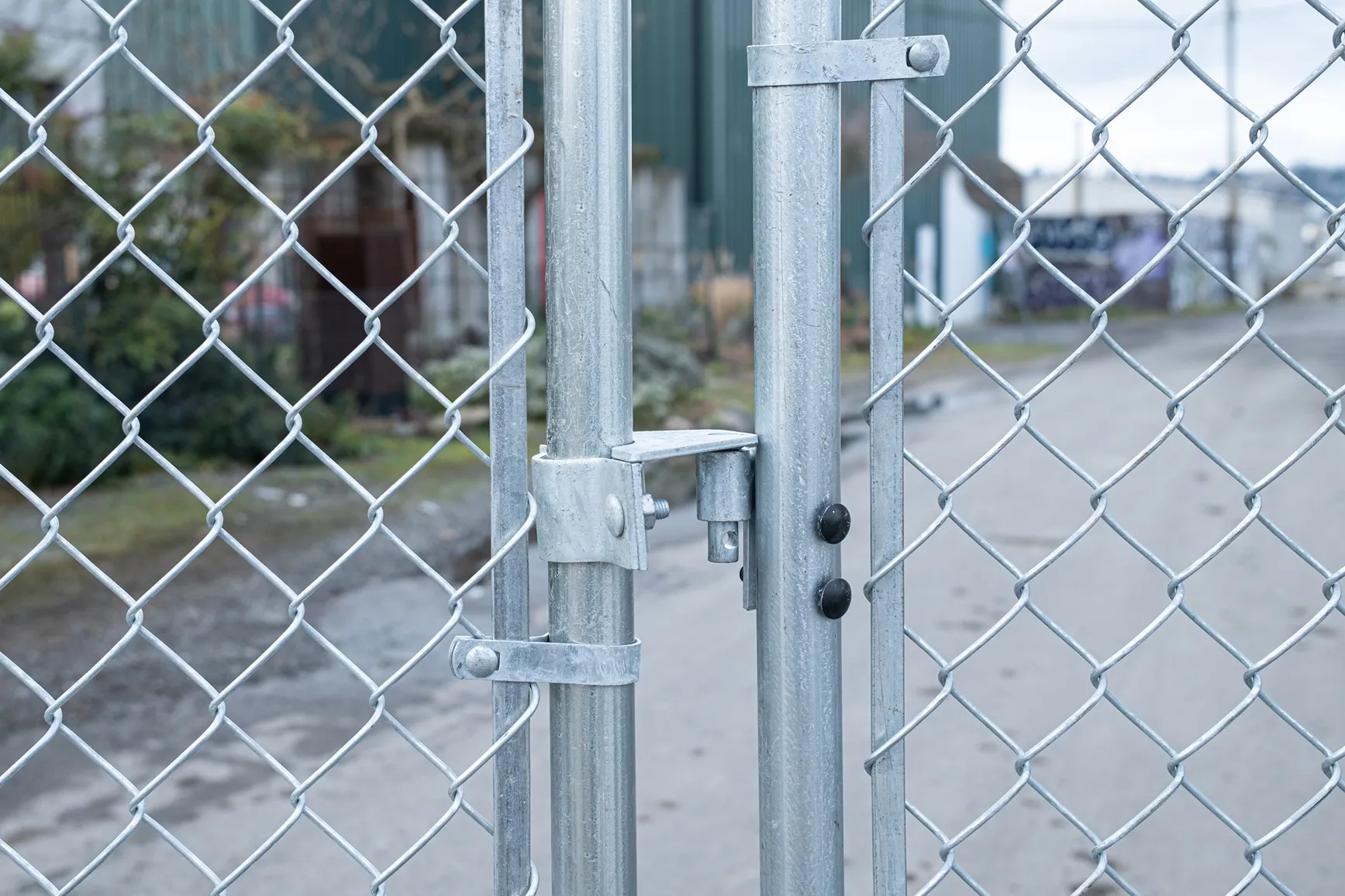 Chain link fence security installation with hardware and gate fittings for a Seattle business property