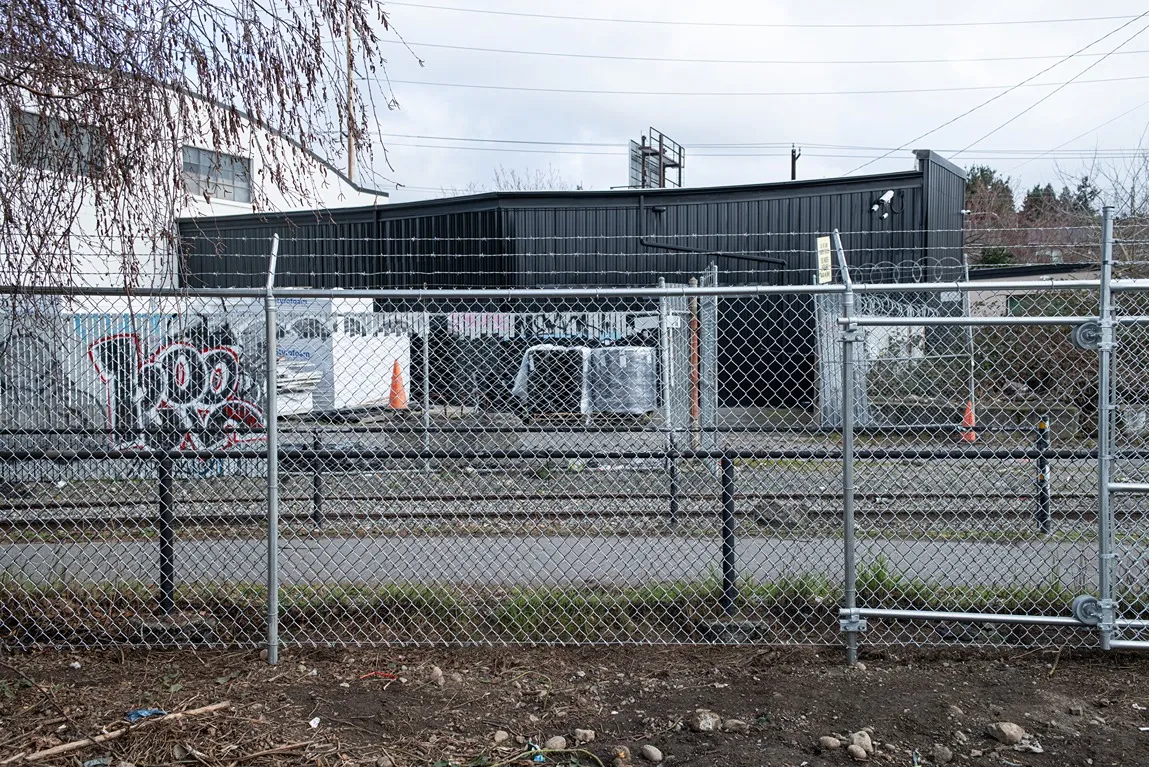 High security chain link fence with tension wire and bottom rail installed along a commercial perimeter in Seattle