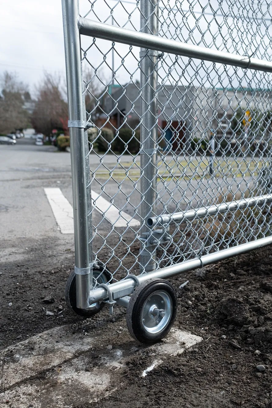 Black vinyl-coated security chain link fence with secure gate access at a Seattle commercial property