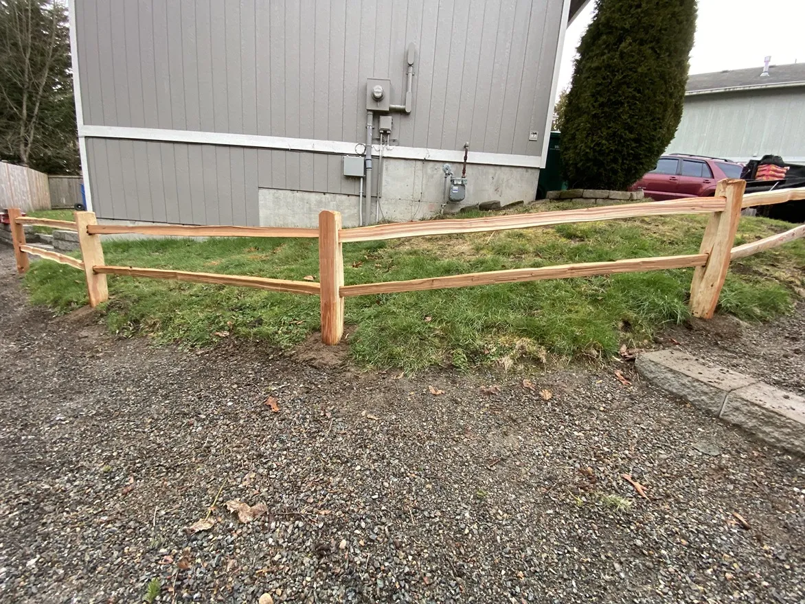 Natural split rail fence with cedar rails defining a property boundary in the Greater Seattle area