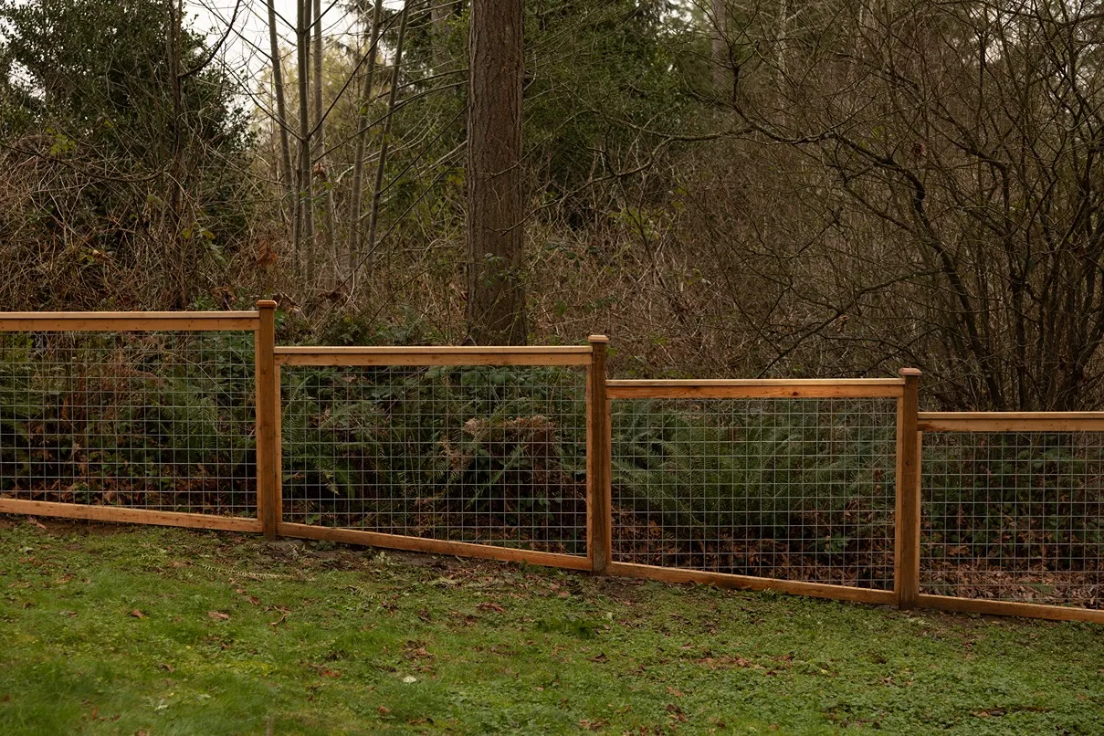 Cedar hog wire fence built on a sloped remote property in King County