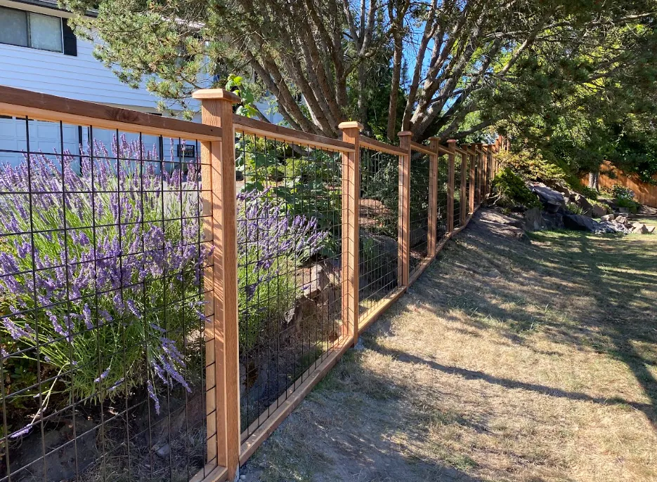 Cedar hog wire fence installed in a sloped property in Seattle