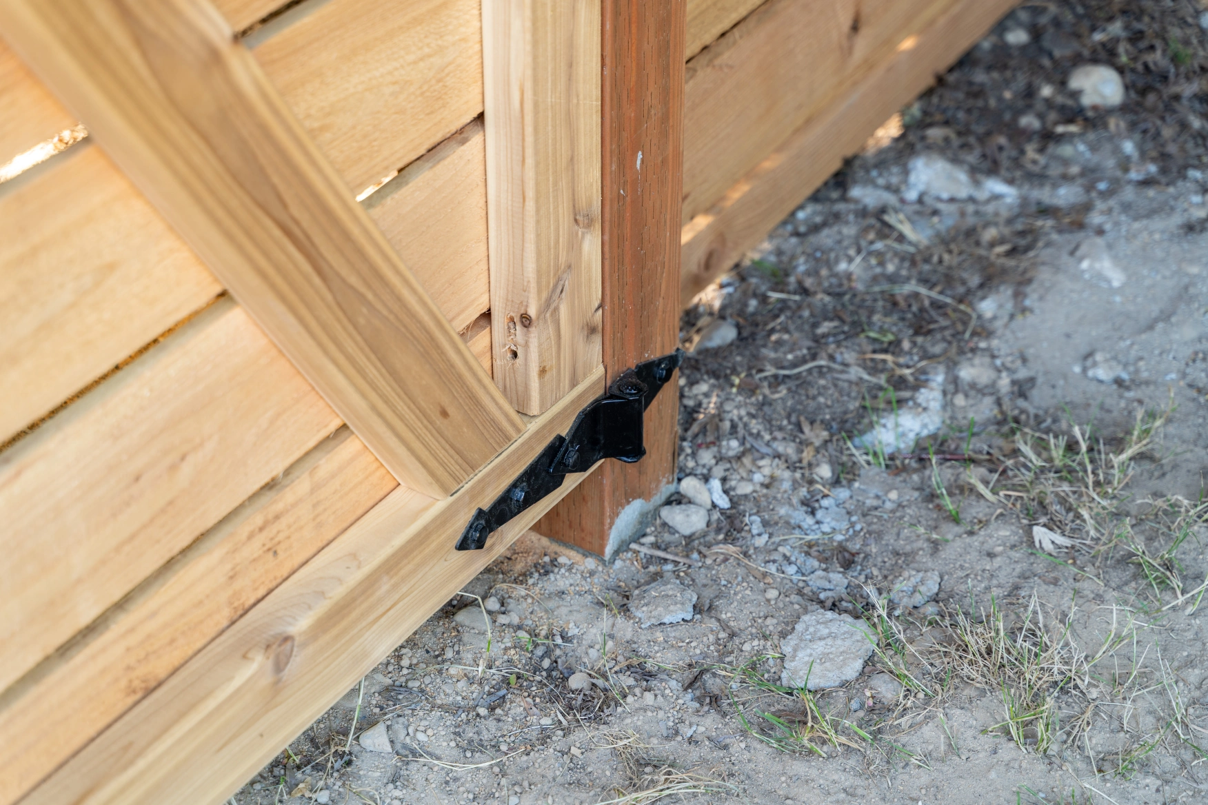 Close-up of pressure-treated jumbo fence post finished flush