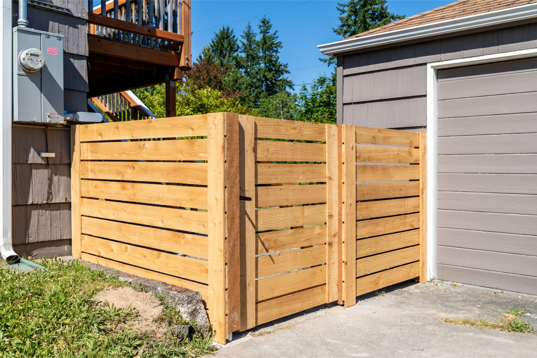 Matching horizontal cedar gates installed for backyard privacy