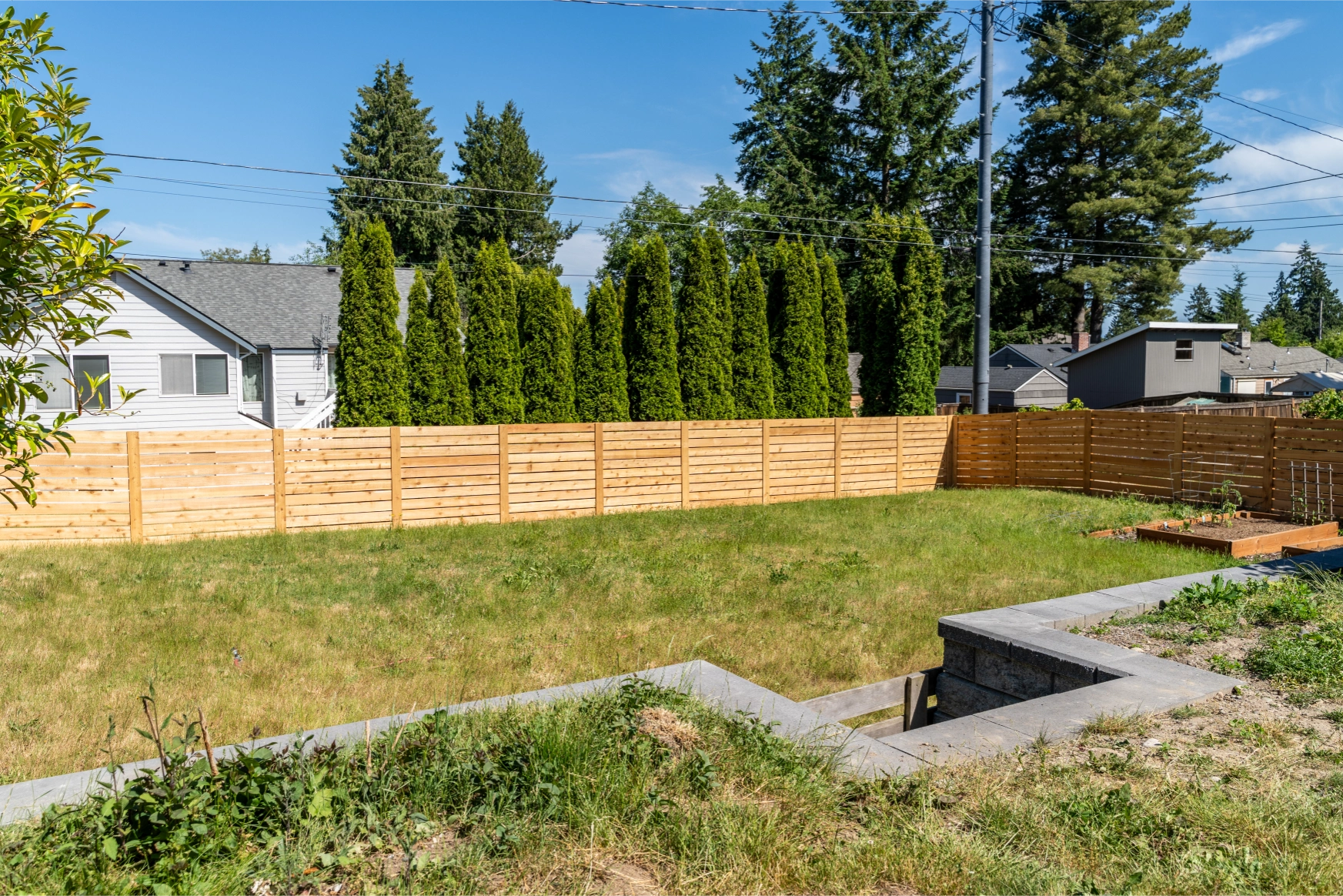Wide view of modern horizontal cedar fence installation in Shoreline