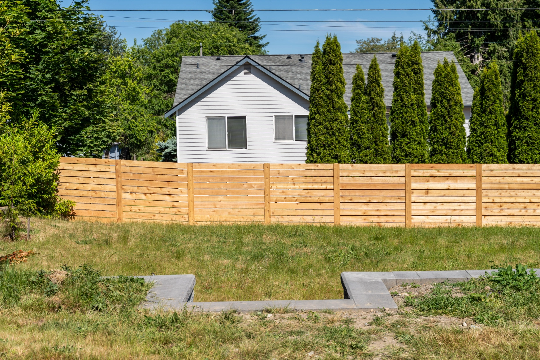 Horizontal cedar privacy fence enclosing backyard in Shoreline WA 98155