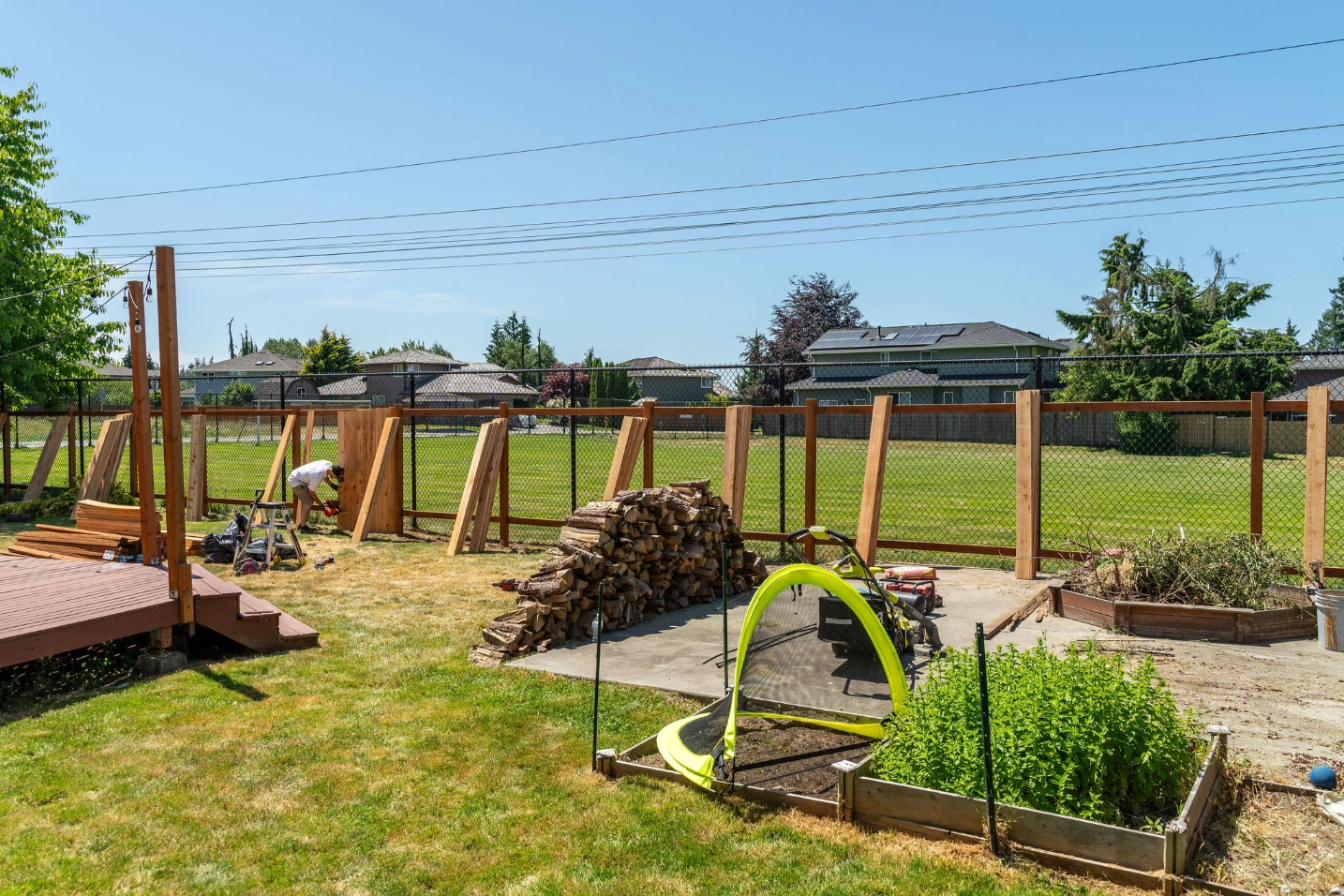 Cedar fence framing installed along chain link boundary for added privacy in Snohomish WA