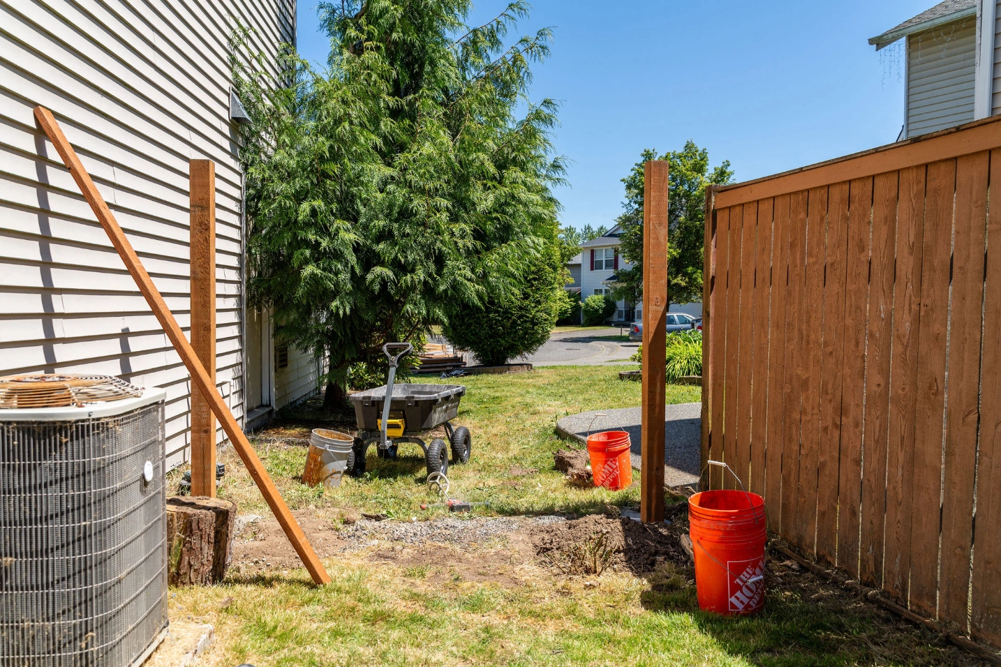 Crew attaching cedar fence framing over existing chain link fence in Snohomish Washington
