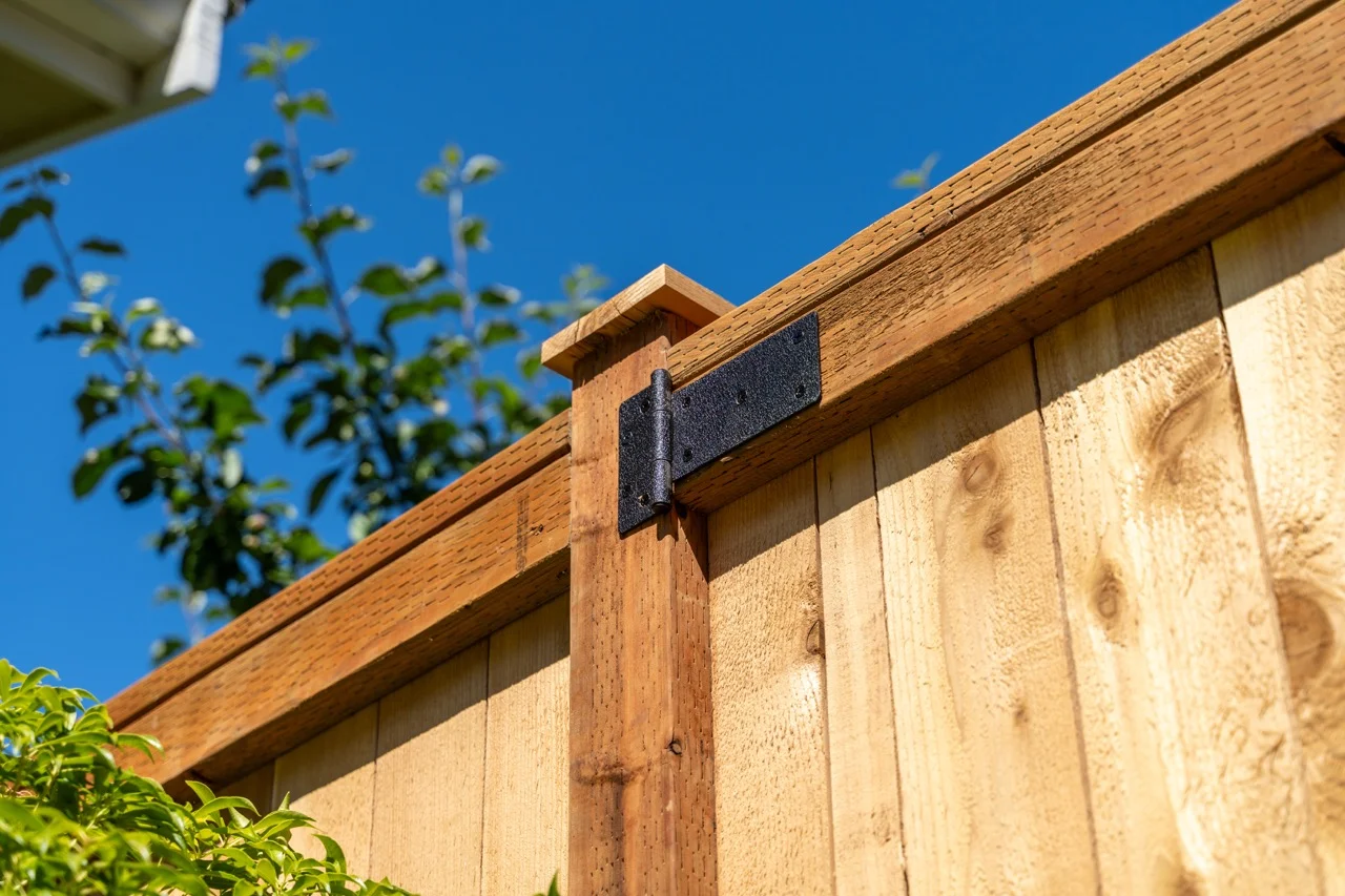 Close-up view of a wooden fence post detail, showing natural grain texture and wood fence installation quality.