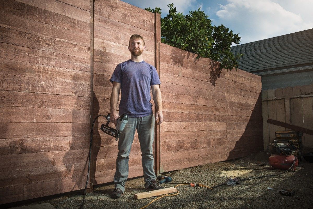 Contractor After completing Wood fence replacement project in Seattle