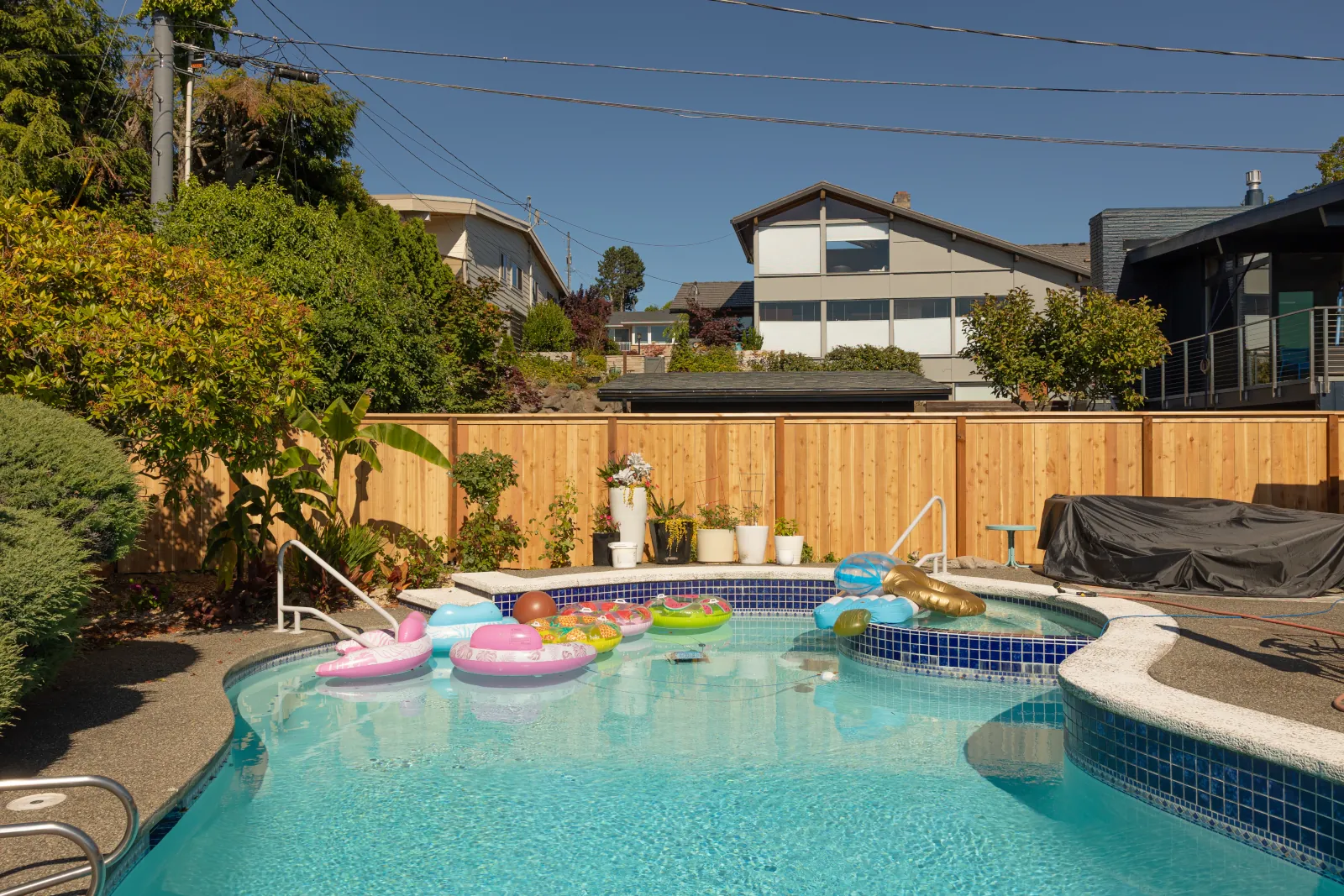 New cedar privacy fence surrounding a backyard swimming pool