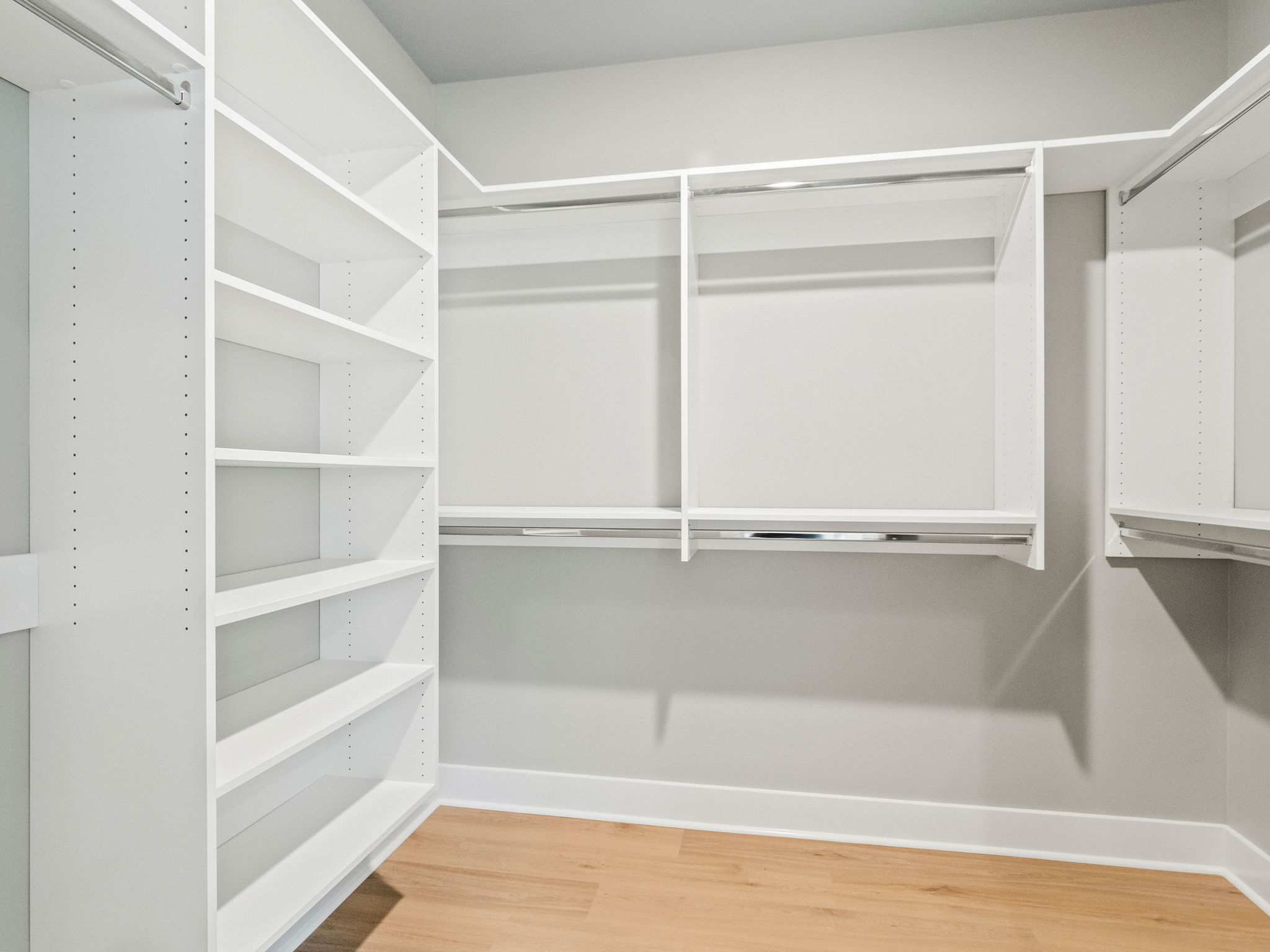 Large primary closet with lots of space for clothes, shoes, and more