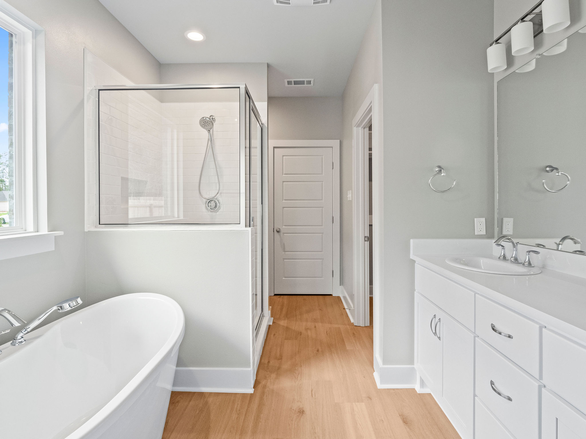 Large primary bathroom with soaking tub and glass shower